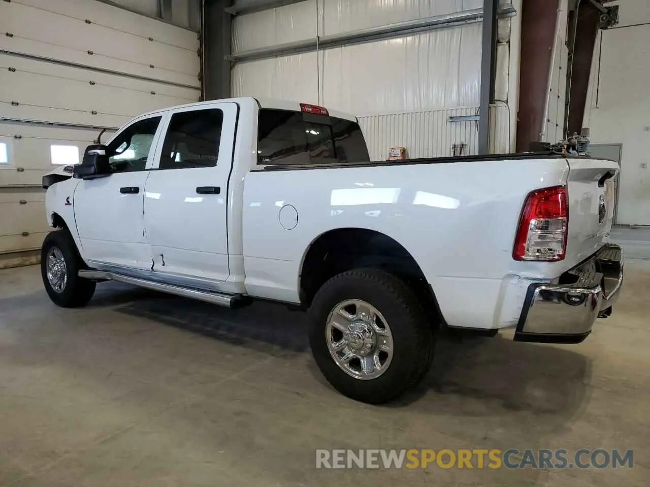 2 Photograph of a damaged car 3C6UR5CL0PG503647 RAM 2500 2023
