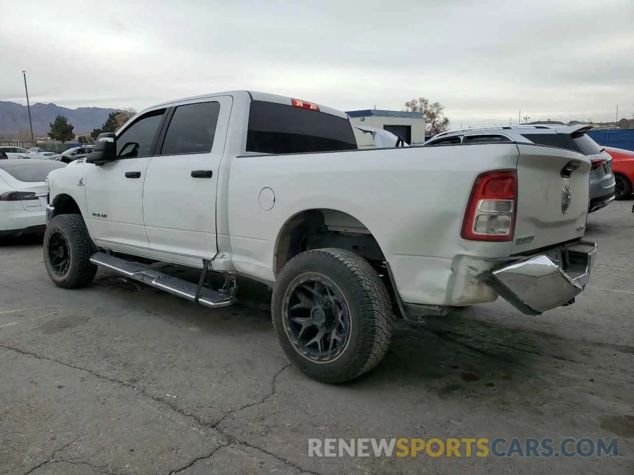 2 Photograph of a damaged car 3C6UR5DL0PG613323 RAM 2500 2023