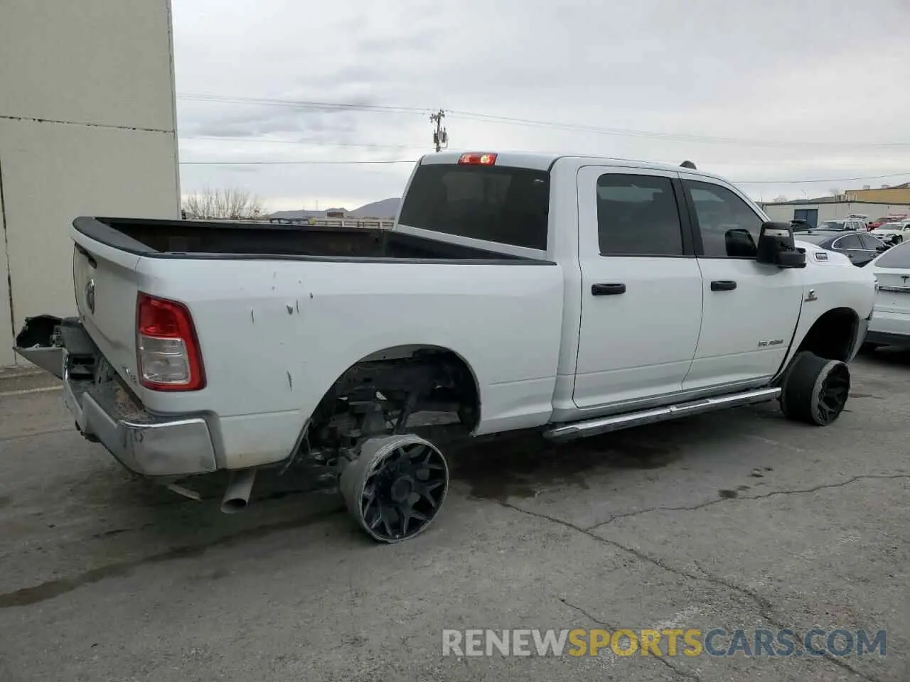 3 Photograph of a damaged car 3C6UR5DL0PG613323 RAM 2500 2023