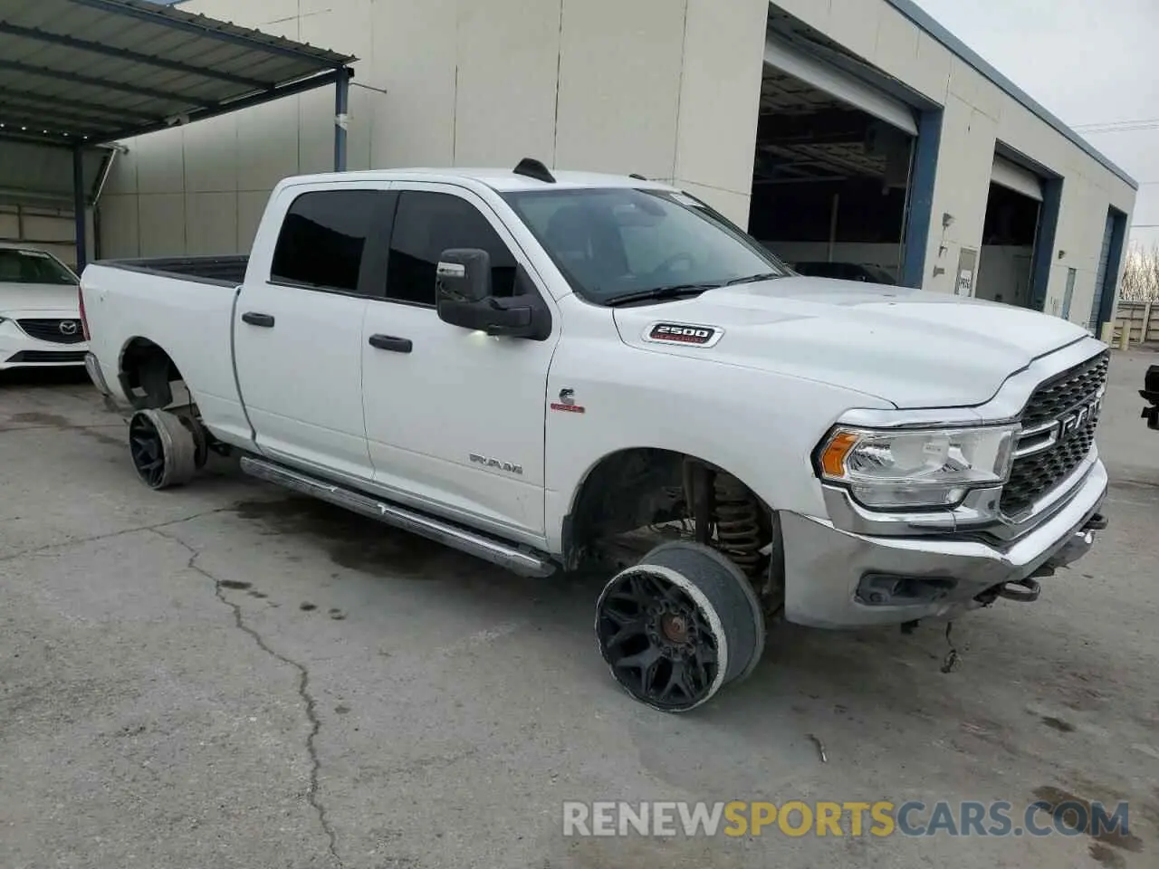 4 Photograph of a damaged car 3C6UR5DL0PG613323 RAM 2500 2023