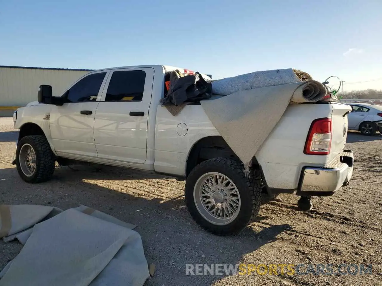2 Photograph of a damaged car 3C6UR5CL0RG117345 RAM 2500 2024